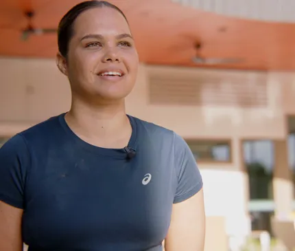 JCU Occupational Therapy student Jaydah Savage talking to cameras in front of the JCU Halls of Residence project