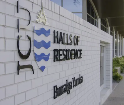 JCU Halls Of Residence Front Entrance Signage Jcu Logo White Brick Wall