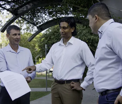 NAIF Staff CEO Craig Doyle Indigenous Outcomes Director Darren Chong And Senior Associate Jamari Buli Pointing To IES Report In Park