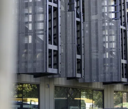 Two Workers In Orange High Vis Uniform On A Yellow Scissor Lift At JCU Engineering And Innovation Place