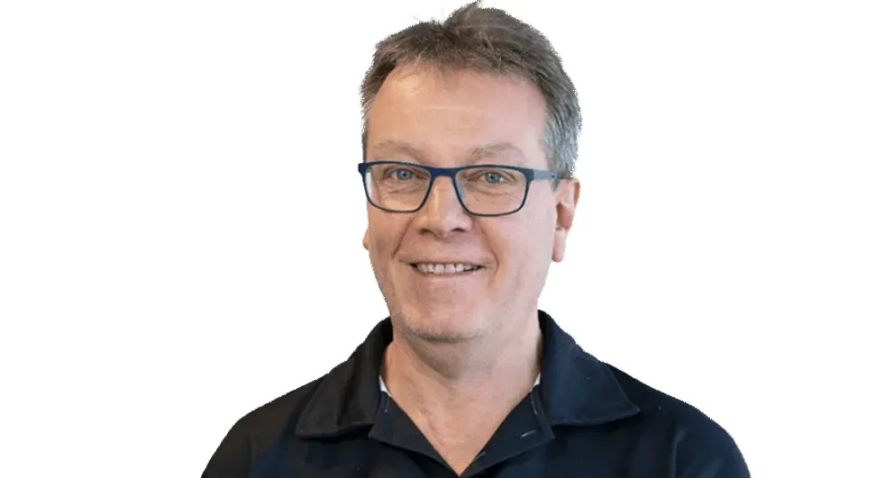 Mr Jim Betts wearing a black button up shirt.